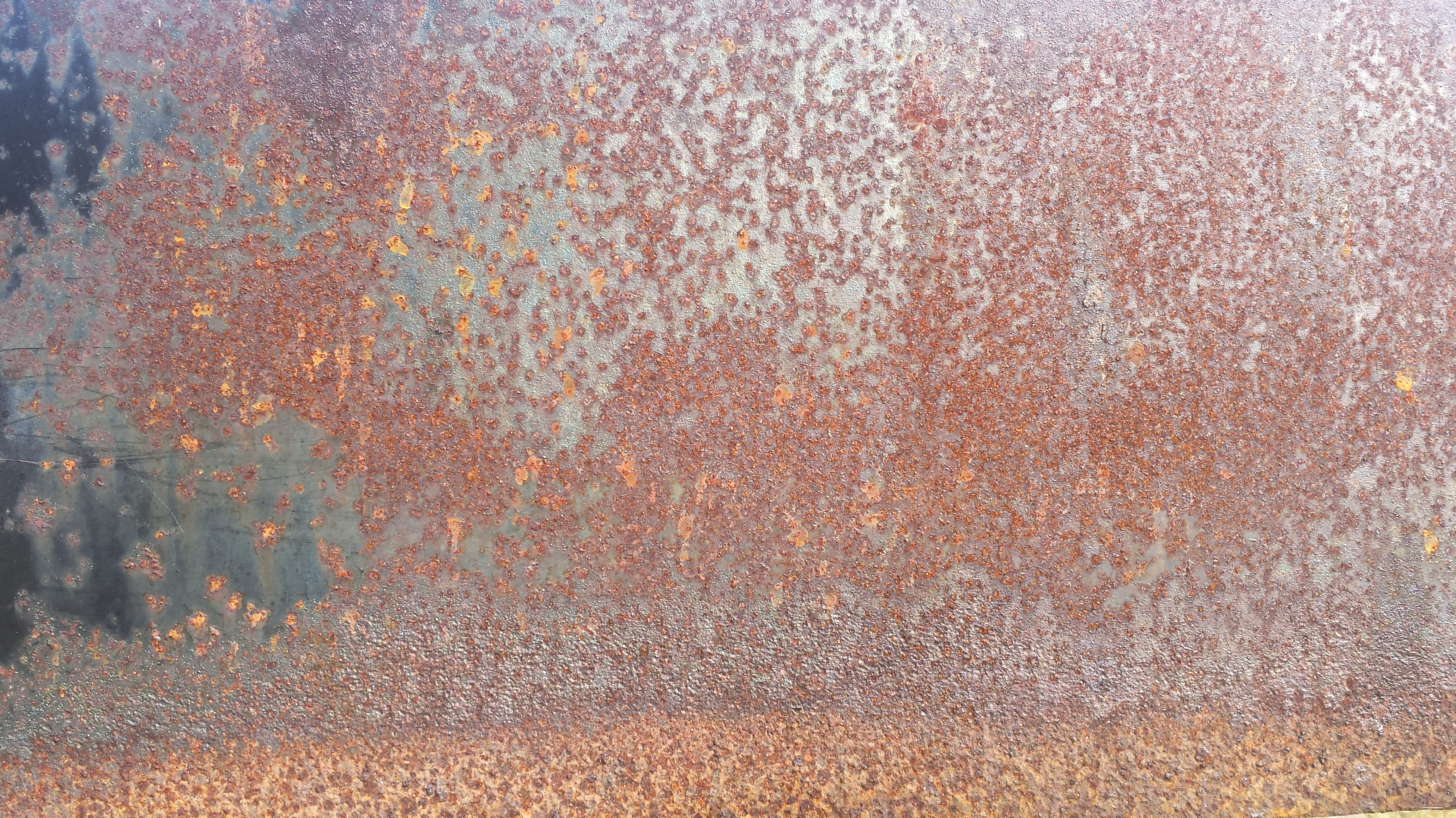 The rusty back of a public barbeque in a park on the Ottawa River